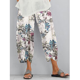 Calças casuais para mulher com cintura elástica, bainha irregular e bolsos, decoradas com estampa floral retrô